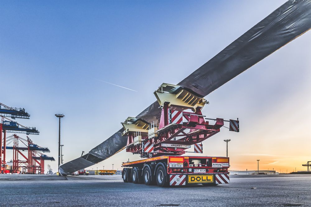 DOLL heavy transport vehicle for wind turbines at the harbor at sunset