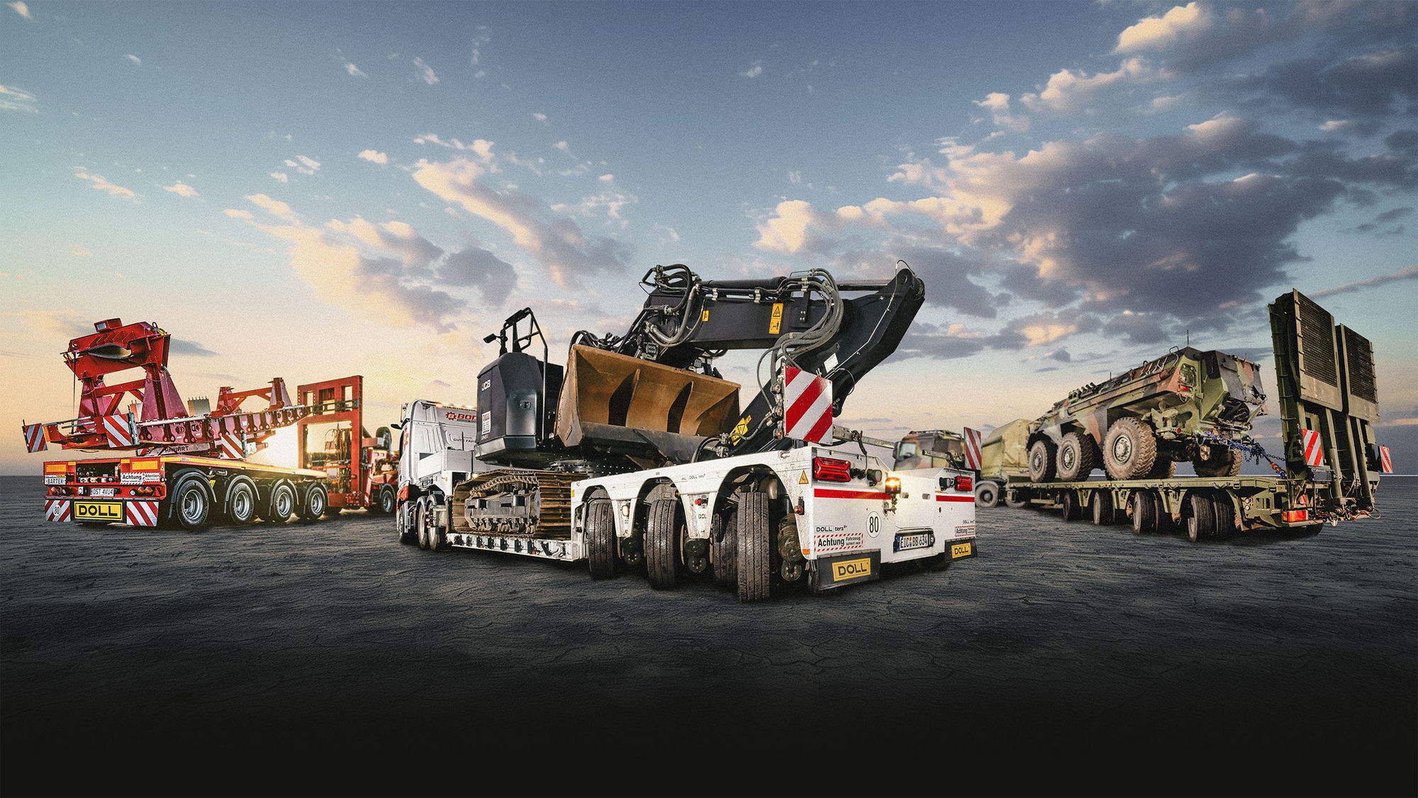 Heavy haulage with low-loaders carrying construction and military vehicles under a dramatic sky.