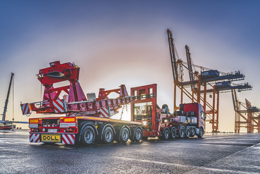 Heavy transport vehicle from DOLL for wind turbines at the port at sunset
