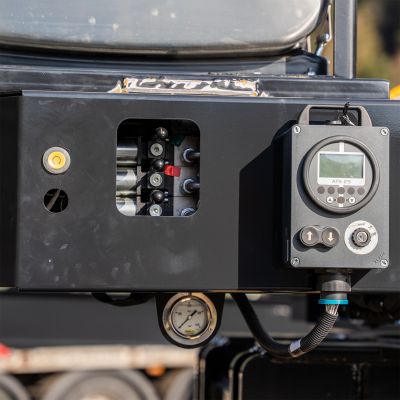 Close-up of a hydraulic and control system with a display and pressure gauge on a DOLL heavy transport module.