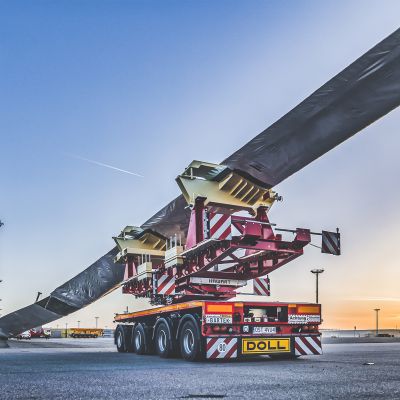 DOLL heavy transport vehicle for wind turbines at the harbor at sunset